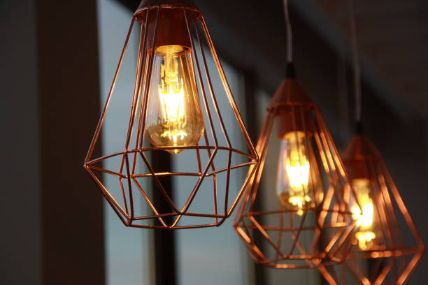 3 vintage-style light bulbs in copper wire cages