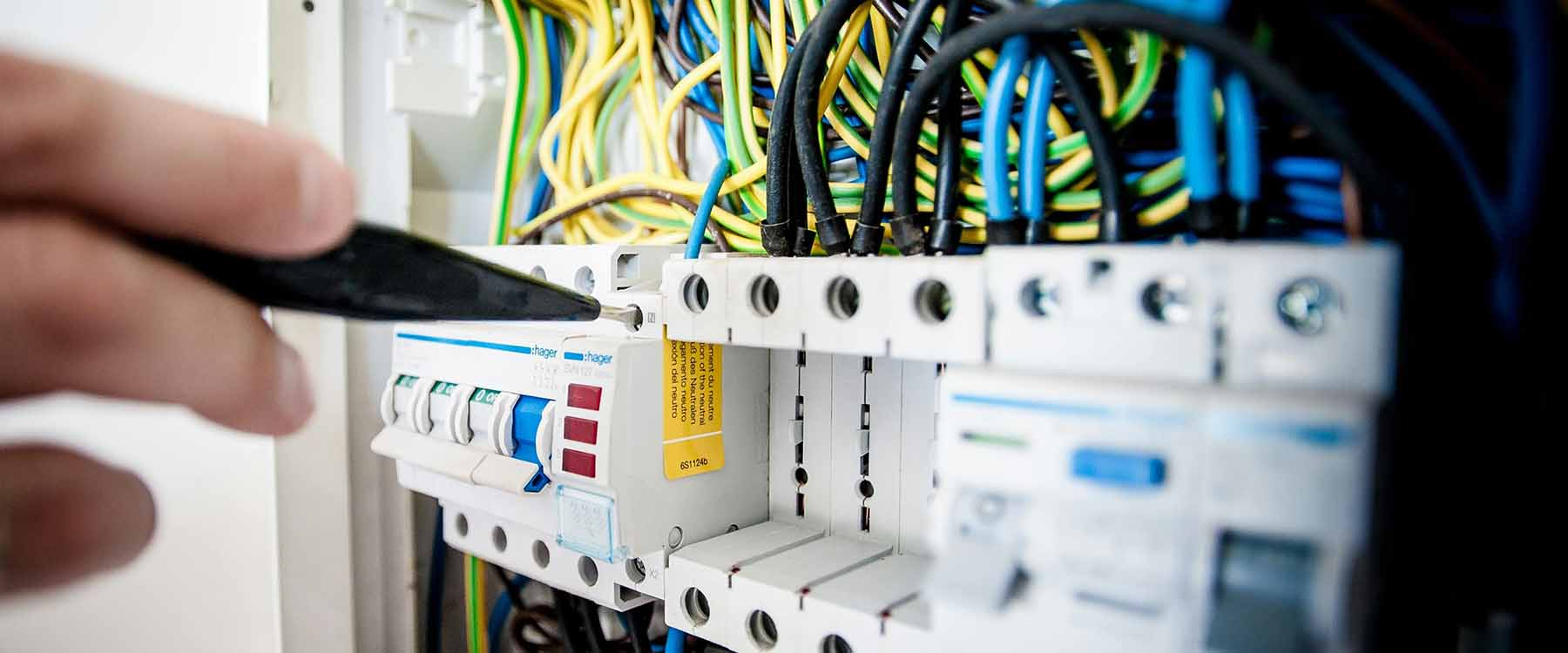 Person working with electrical panel and wires